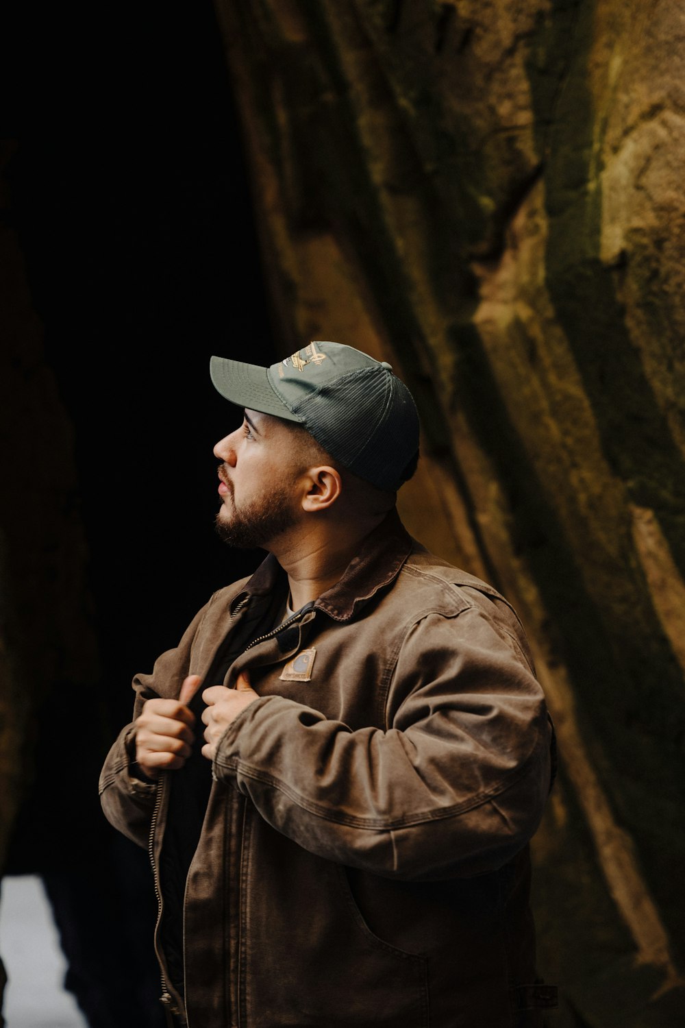 a man standing in front of a cave