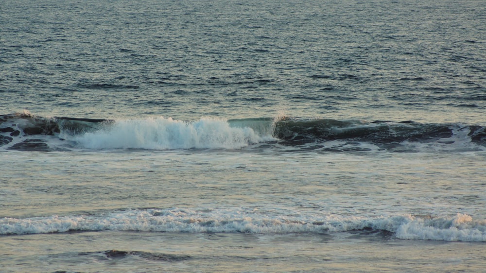 a person riding a surfboard on a wave in the ocean