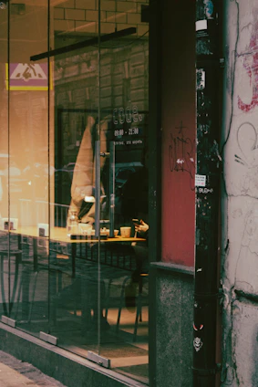 A cozy urban café scene with people chatting and laughing, symbolizing casual connections.