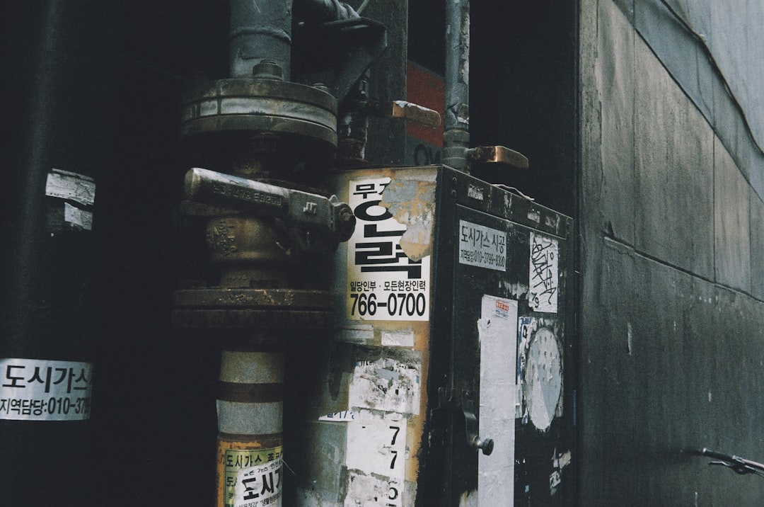a fire hydrant sitting on the side of a building,