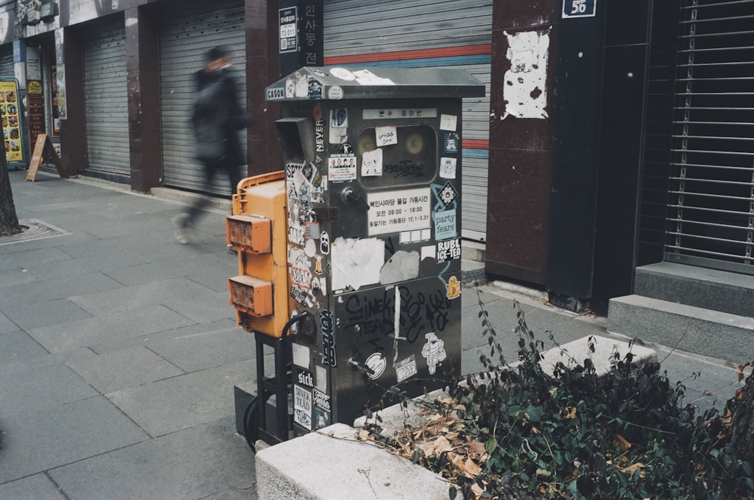 a street scene with a person walking on the sidewalk,