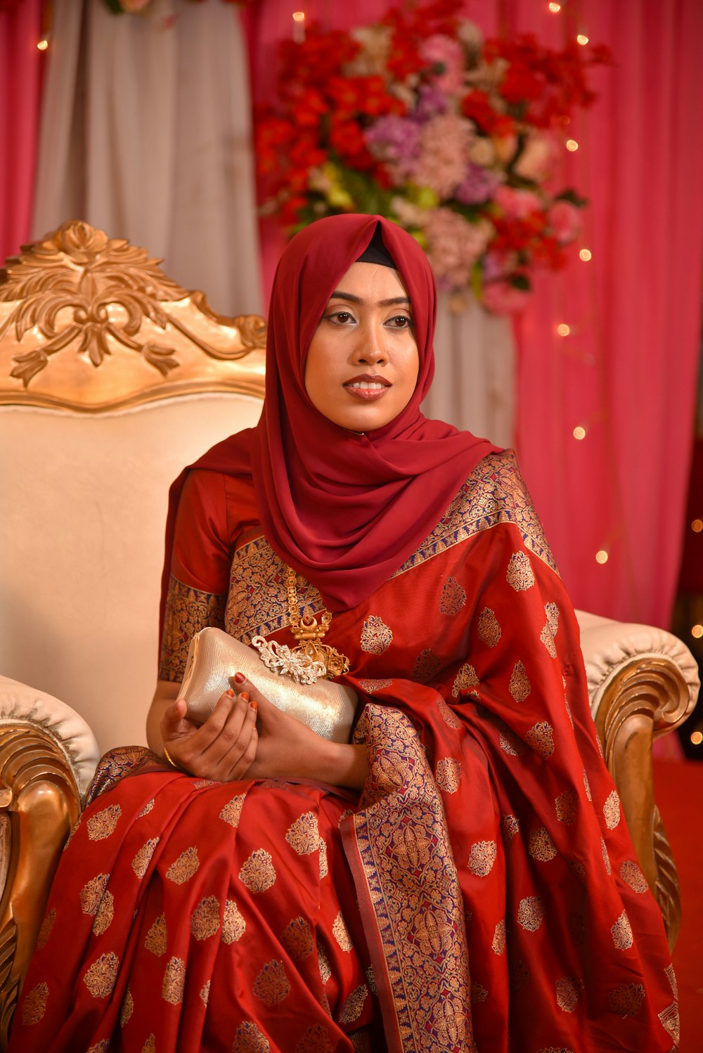 a woman in a red dress sitting on a chair