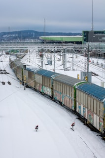 a train traveling through a snow covered countryside