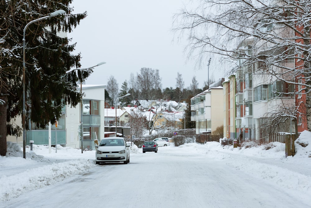 a car driving down a snow covered street