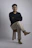 a man sitting on top of a wooden stool