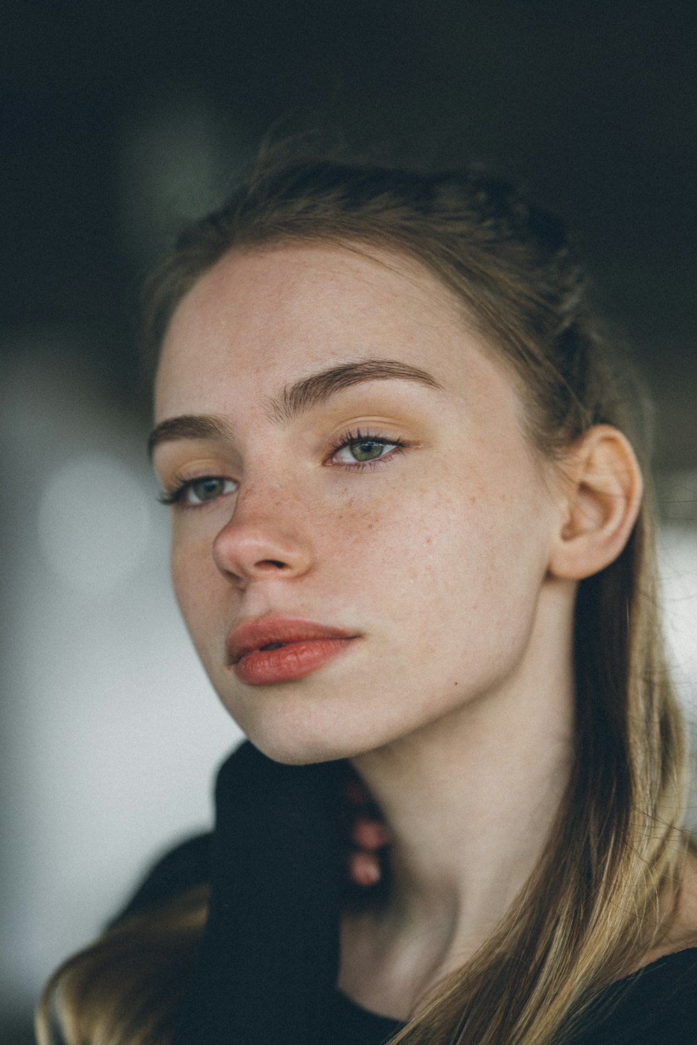 a close up of a woman with a ponytail