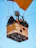A group of friends smiling inside a colorful hot air balloon basket.