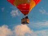 Families smiling inside a spacious hot air balloon basket, ready for adventure.