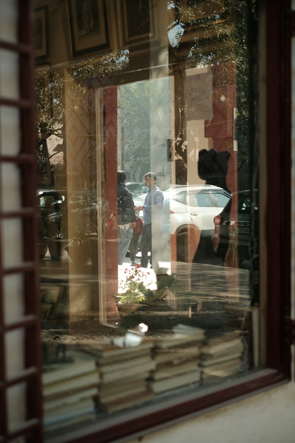 a car is seen through the window of a book store