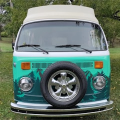 Before and after shots of a campervan body repair with fresh black and lime green paint.