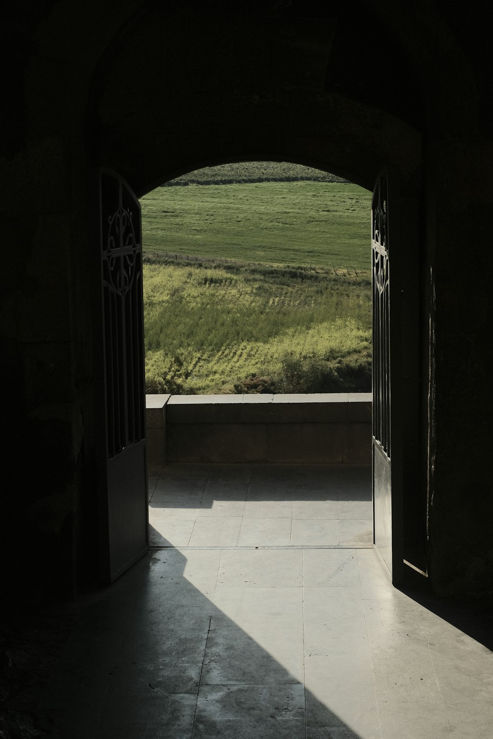 an open door leading to a lush green field