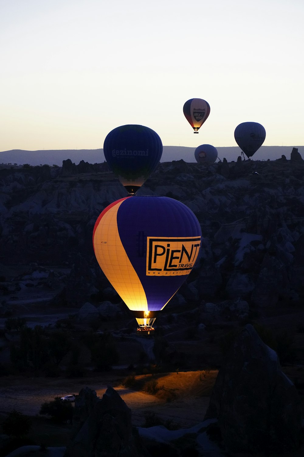 a group of hot air balloons flying in the sky