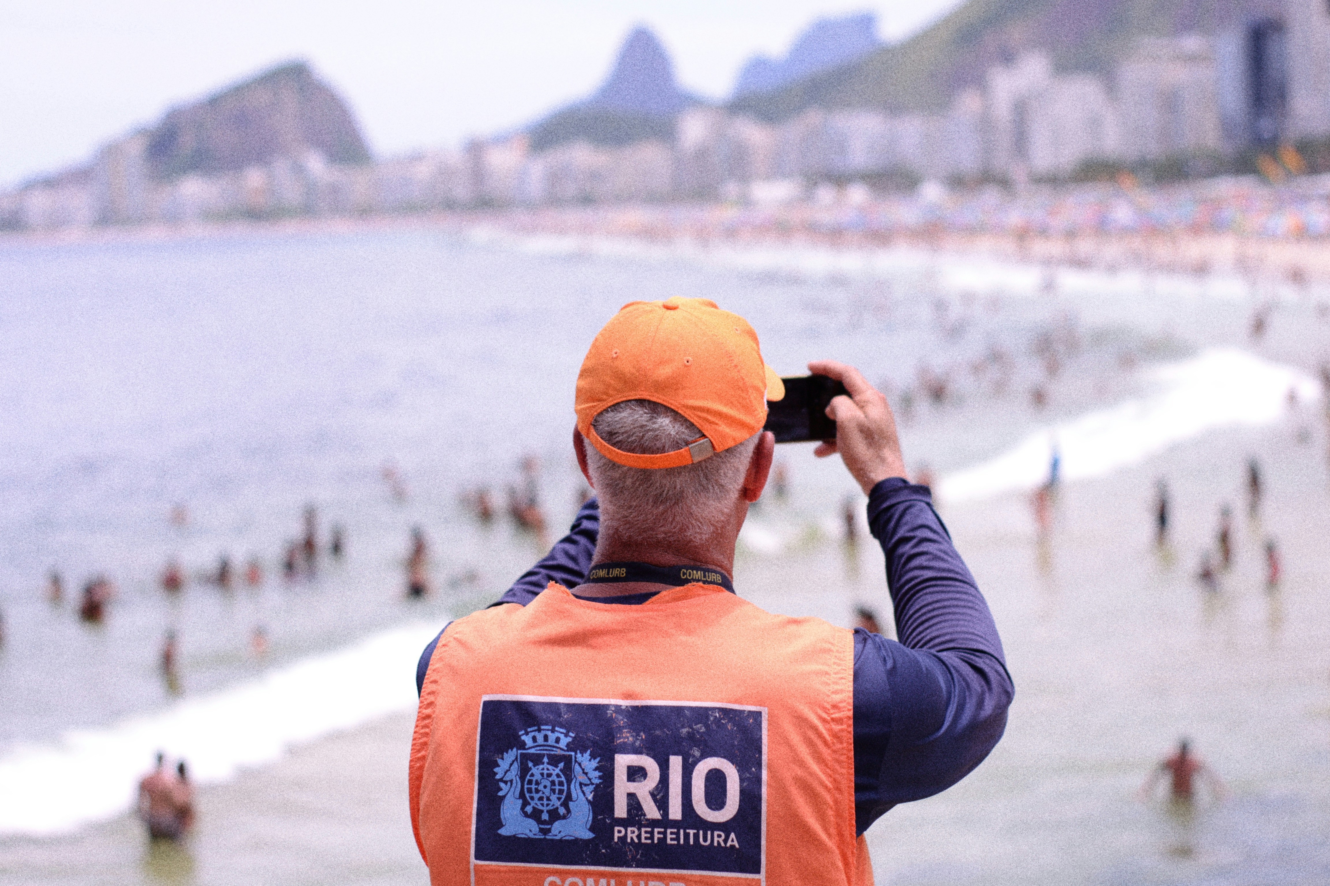Traveler taking photos at a Brazilian beach using a smartphone