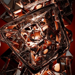 Intricate geometric patterns formed by transparent, angular shapes with reflective surfaces. The composition creates a complex interplay of light and shadow, emphasizing the reflective and refractive properties of the materials.