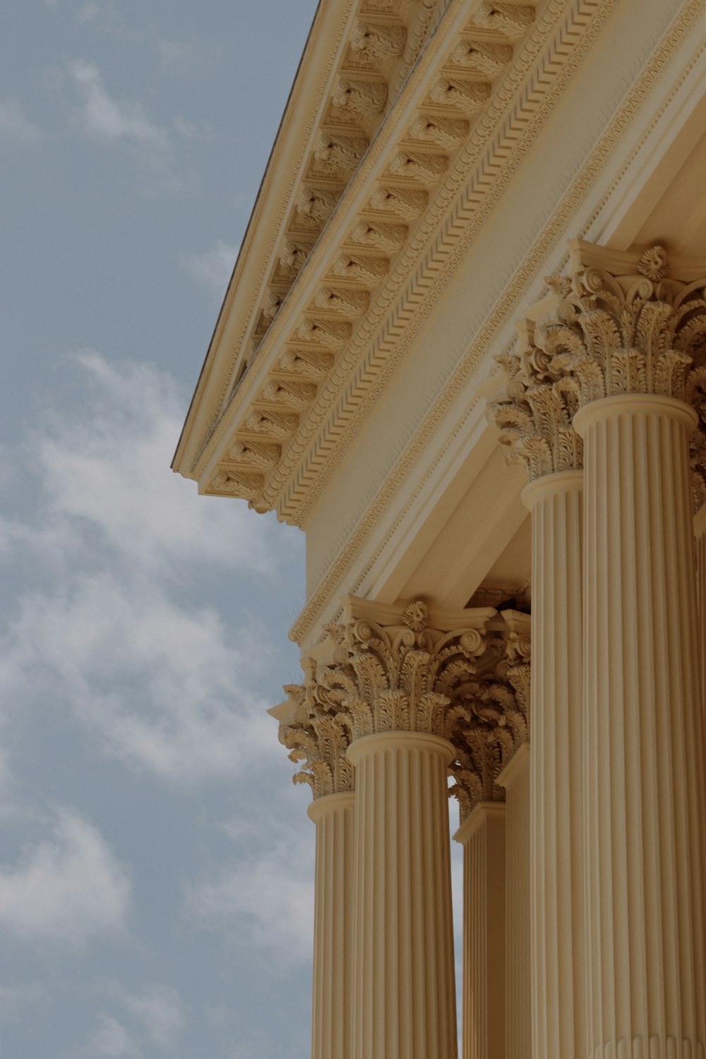 the columns of a building against a blue sky