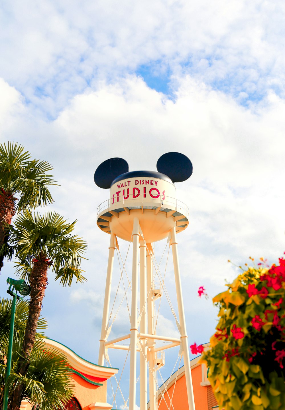 a white tower with a mickey mouse sign on top of it