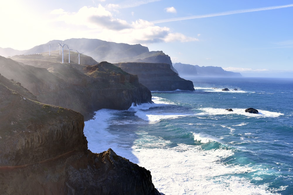 a scenic view of the ocean with a bridge in the distance