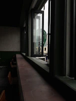 Wide-angle shot of a local food restaurant’s open kitchen and seating area bathed in natural light.