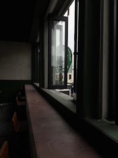 Wide-angle shot of a local food restaurant’s open kitchen and seating area bathed in natural light.
