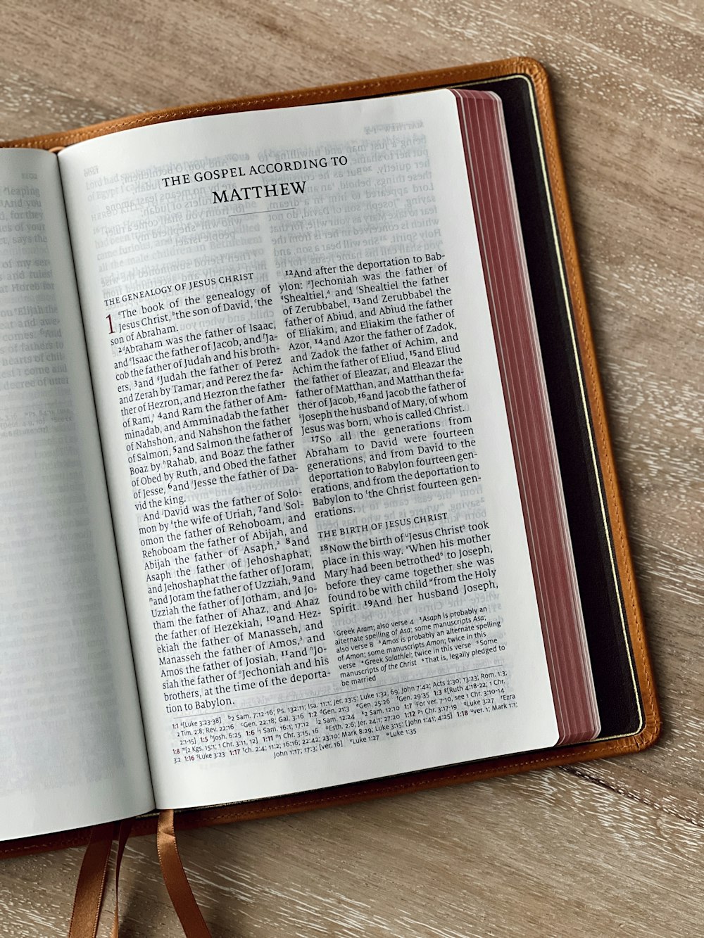 an open bible on a wooden table