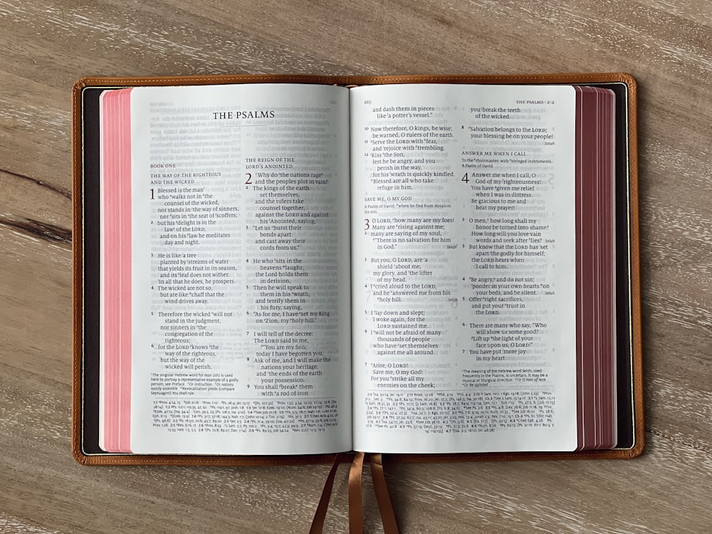 an open book sitting on top of a wooden table