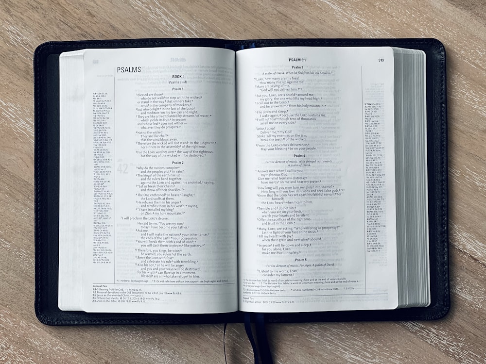 an open book sitting on top of a wooden table