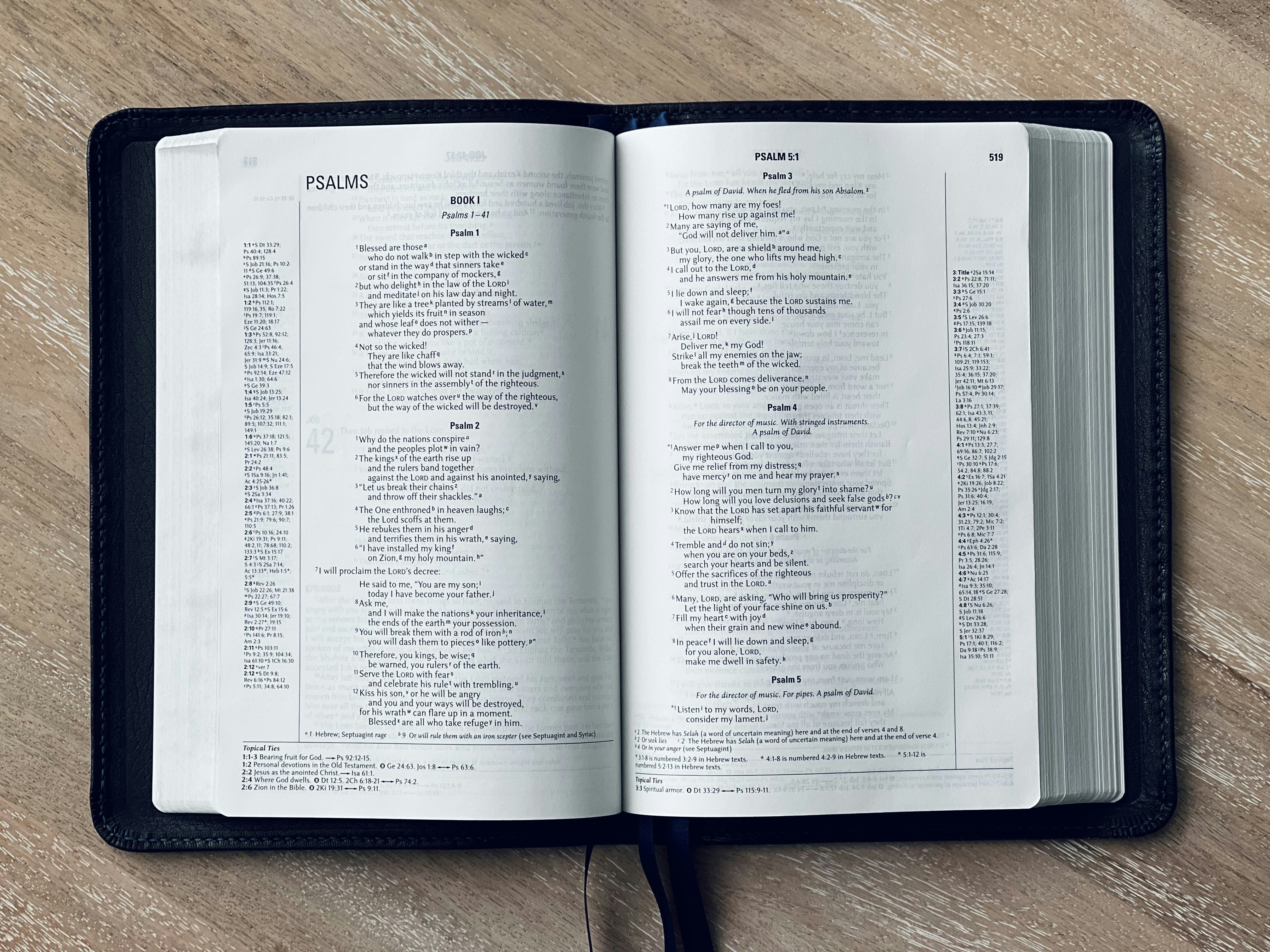 an open book sitting on top of a wooden table