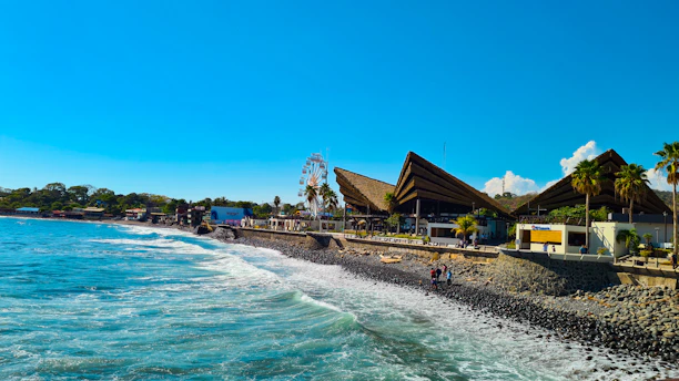a beach next to the ocean with people on it