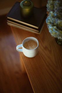Therapist's desk with psychology books and a calming blue mug.