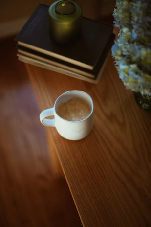Therapist's desk with psychology books and a calming blue mug.