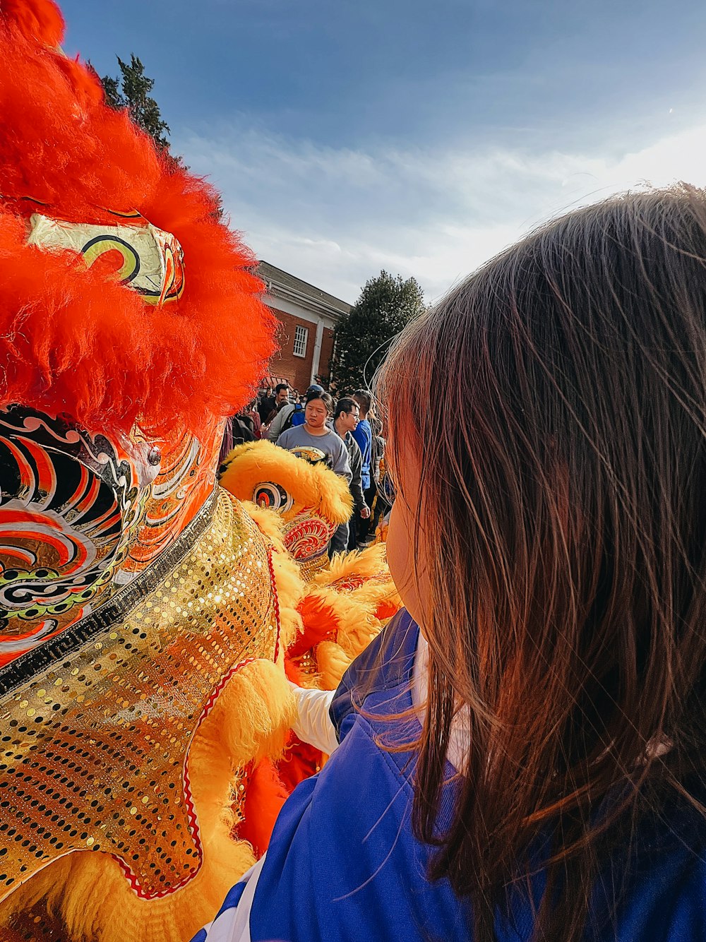 a little girl looking at a dragon costume