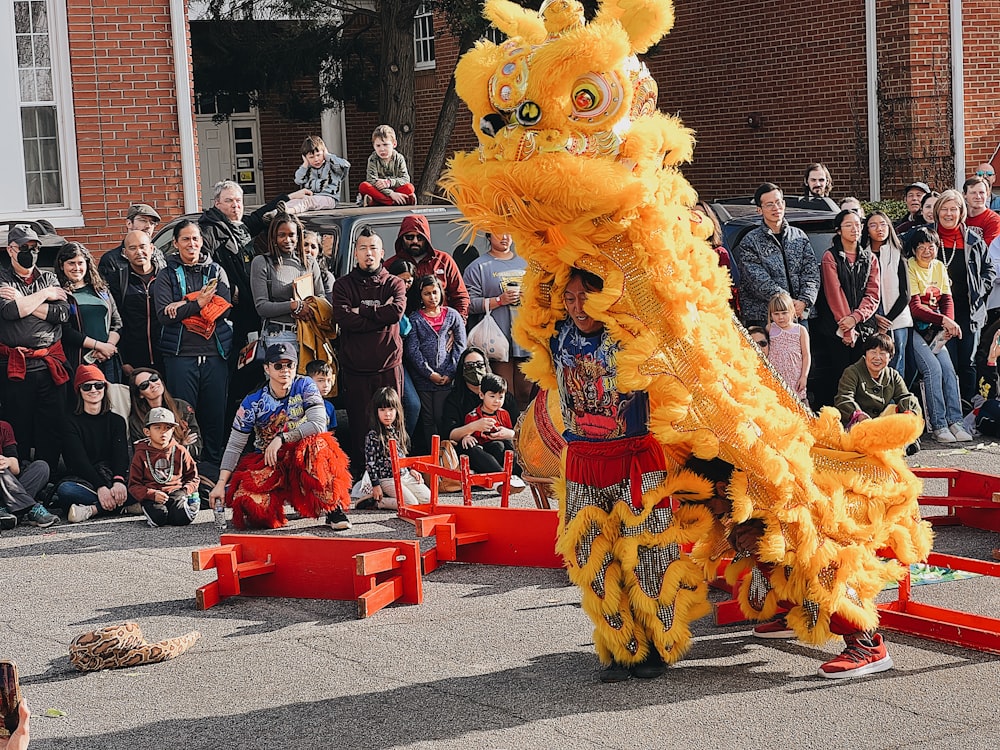 a man in a dragon costume standing in front of a crowd