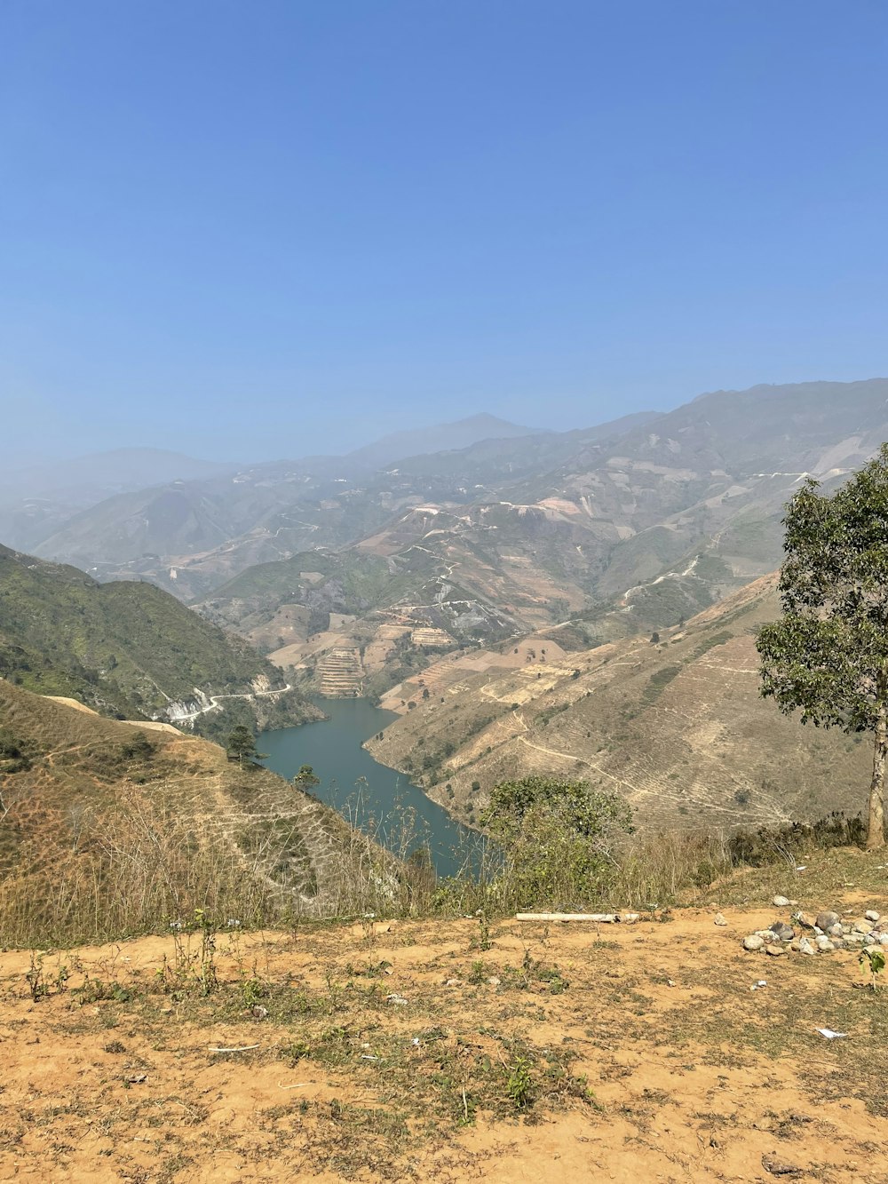 a view of a mountain range with a lake in the foreground