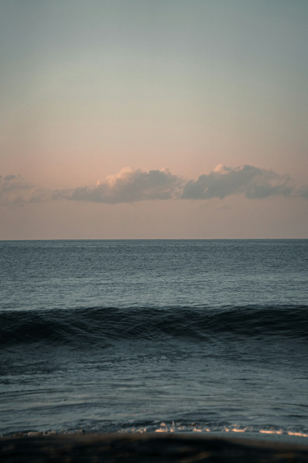 a person riding a surfboard on a wave in the ocean