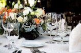 A beautifully arranged wedding table with floral centerpieces.