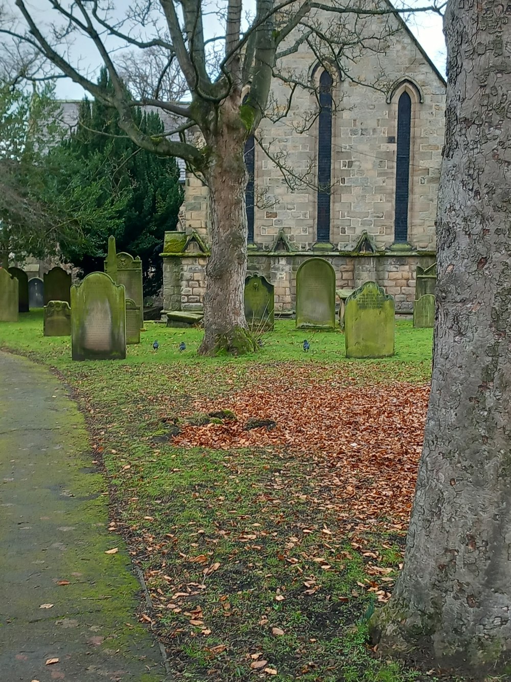 a cemetery in front of an old church