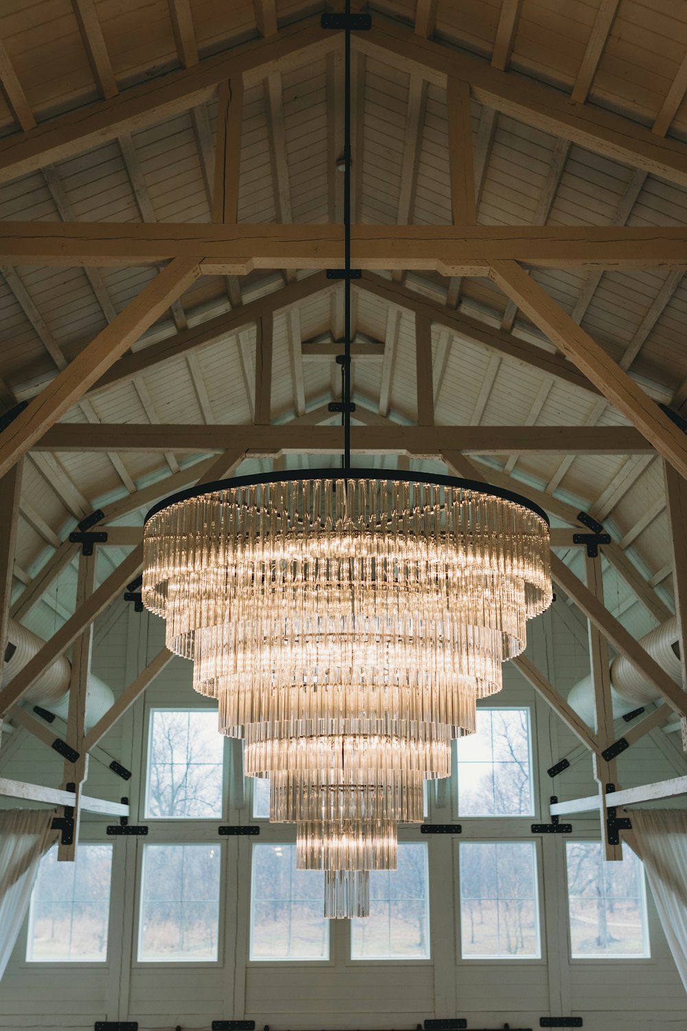 a chandelier hanging from the ceiling of a large room