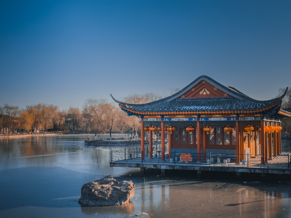 a small pavilion sitting on top of a frozen lake