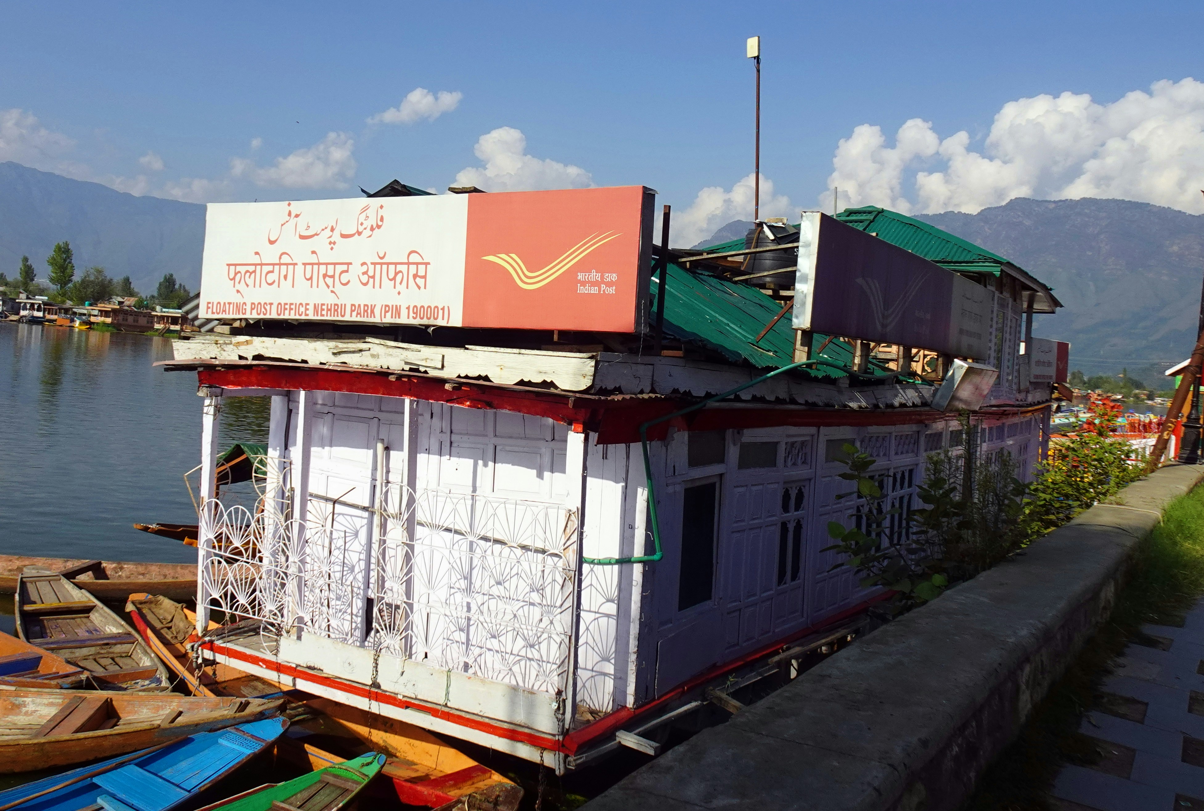 a house boat with a sign on top of it