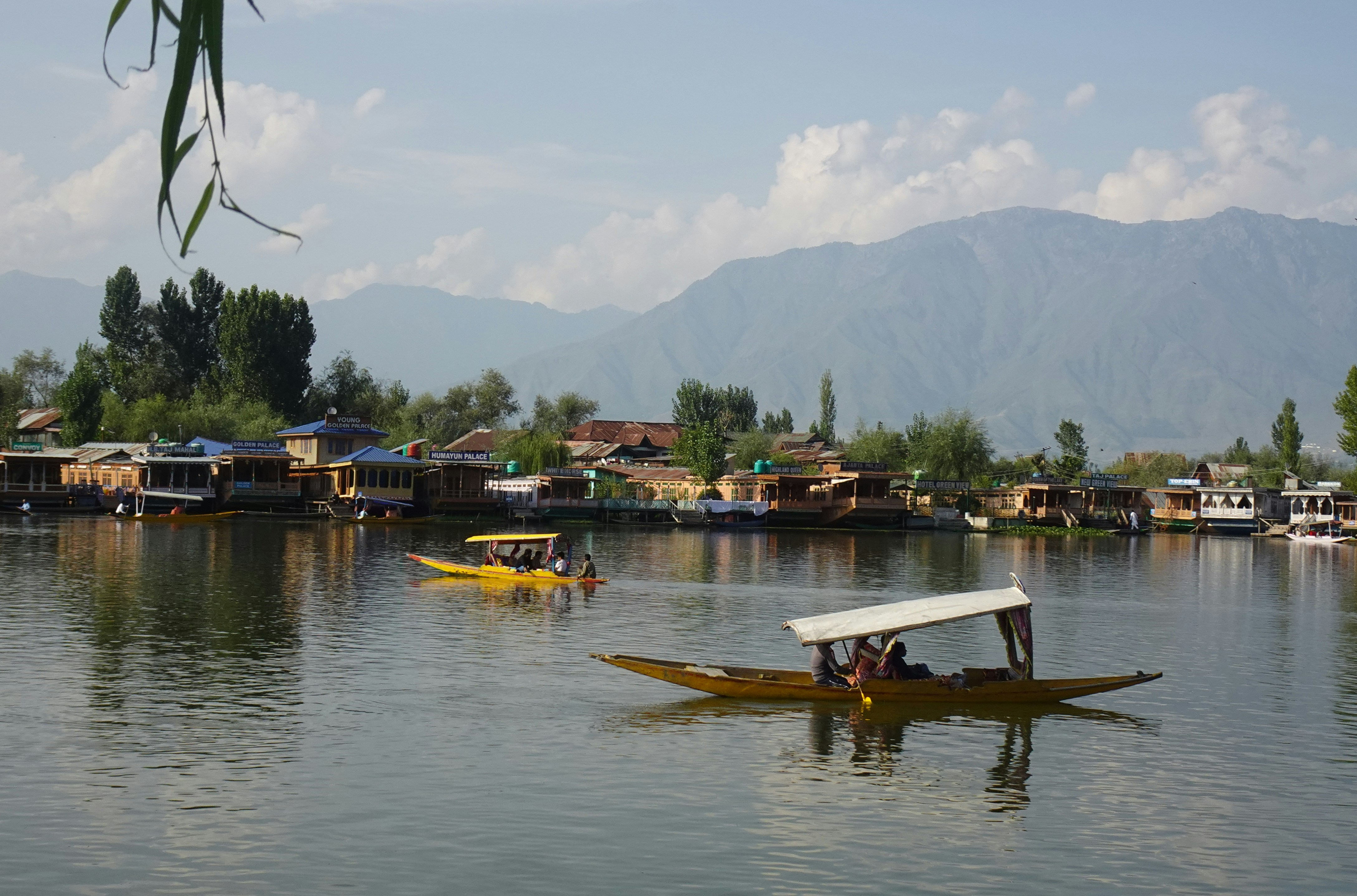 a group of people riding on the back of a yellow boat