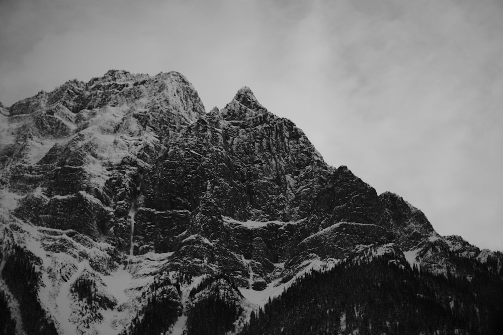 a black and white photo of a snow covered mountain