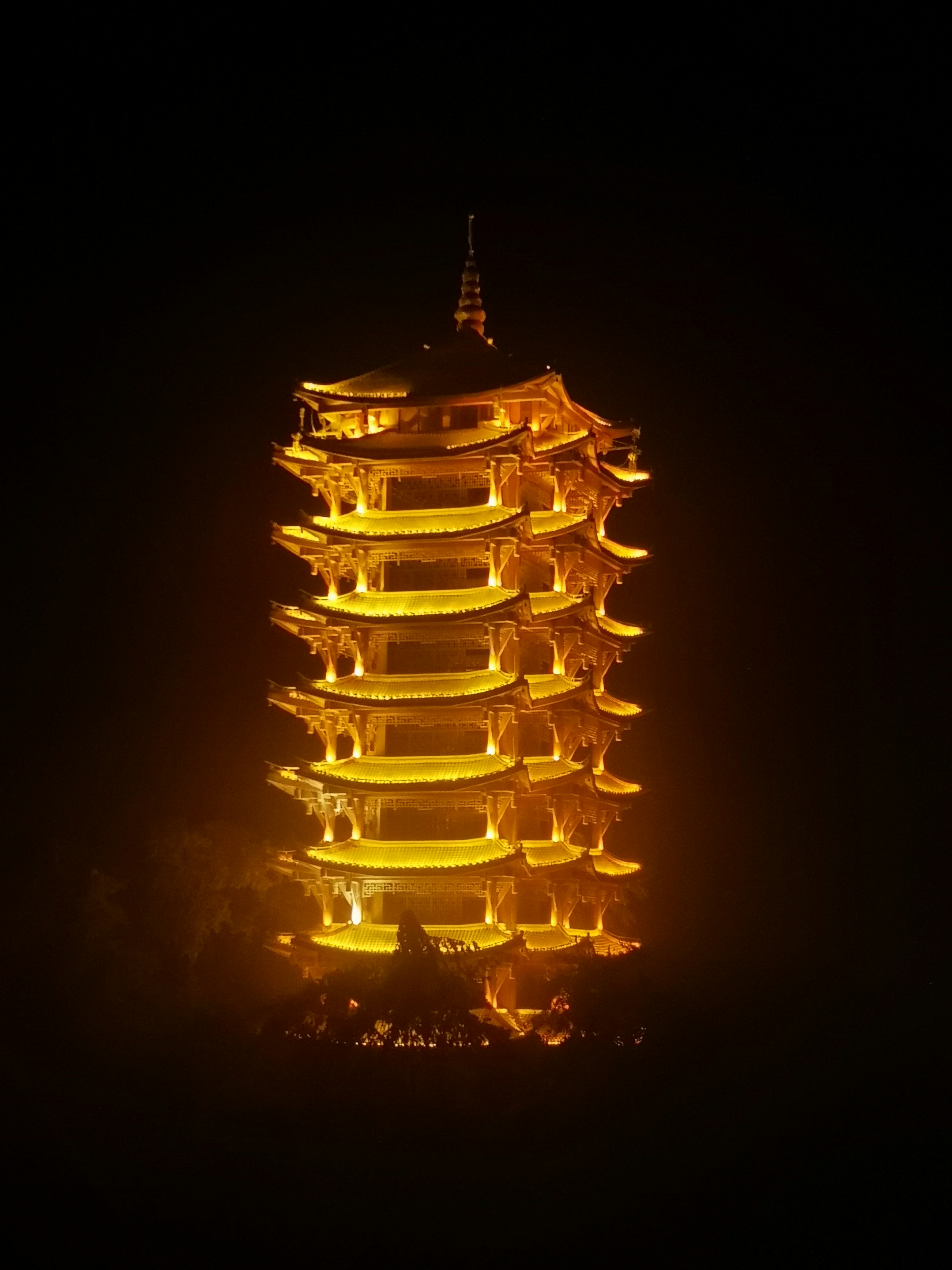 a tall building lit up in the dark