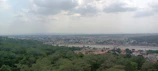 A panoramic view of Raipur city skyline blending urban life with natural greenery.