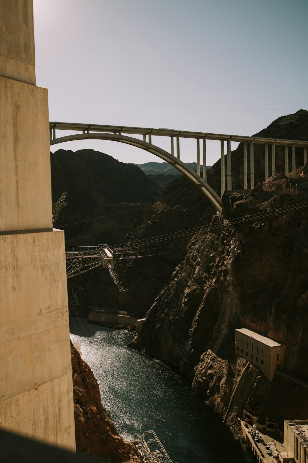 a bridge over a body of water near a mountain