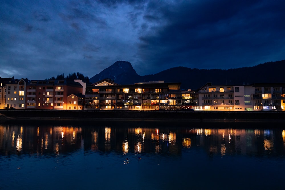 a night time view of a city by the water