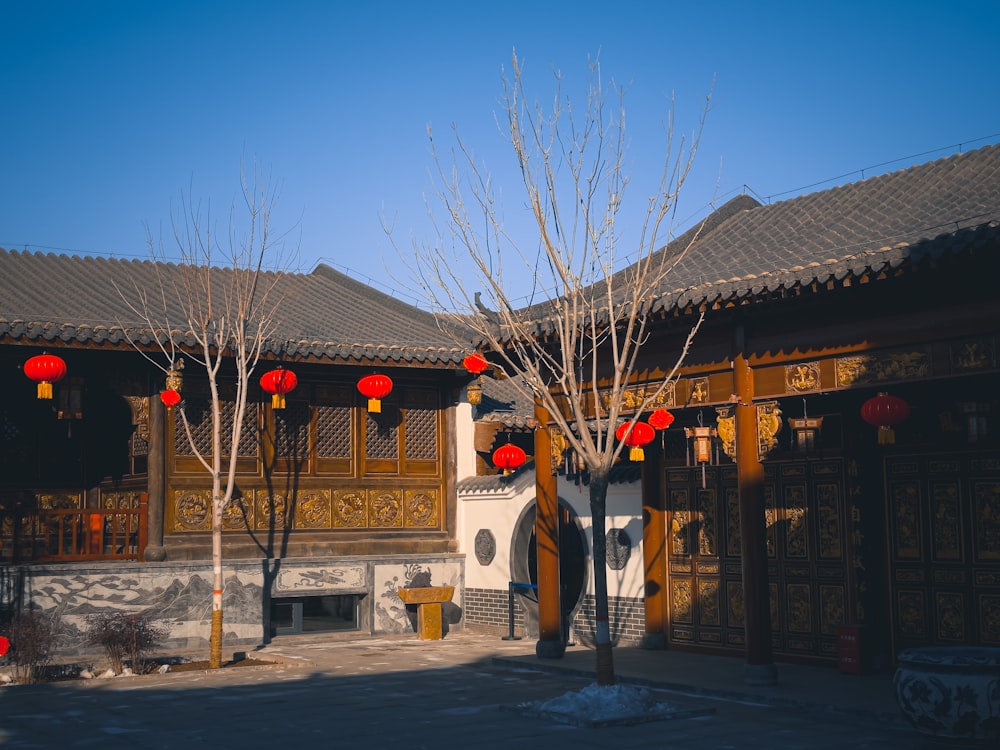 a building with red lanterns hanging from it's roof