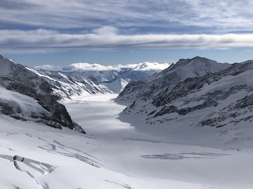 a view of a snowy mountain range with mountains in the background