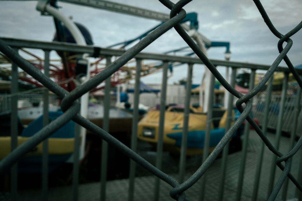 a view of a carnival from behind a fence