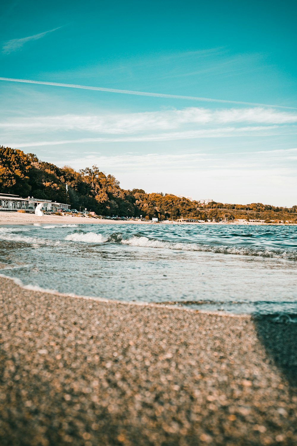 a sandy beach with waves coming in to shore