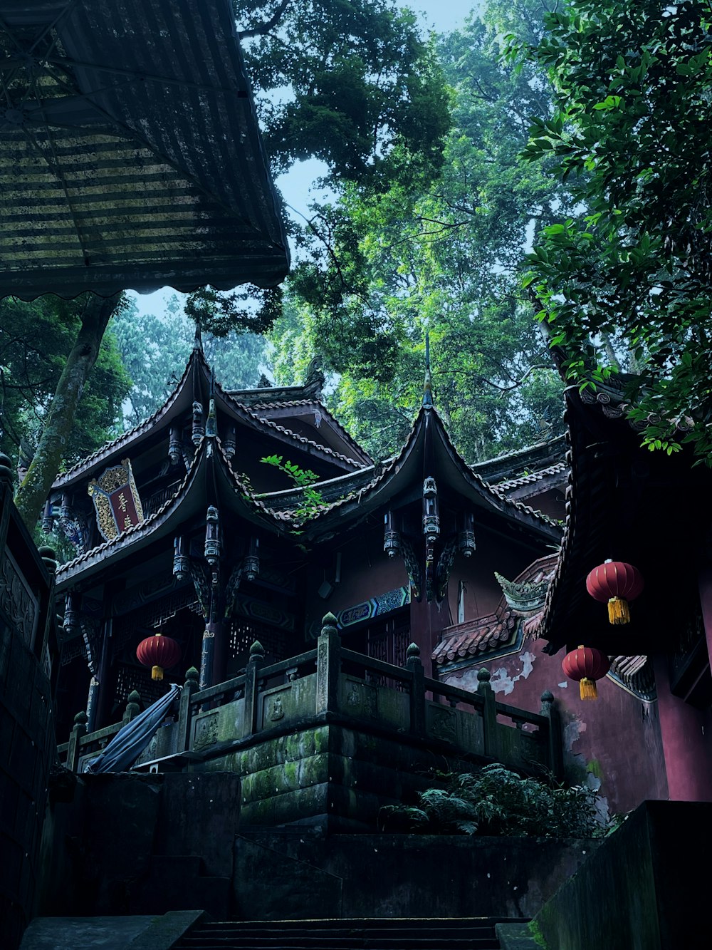 a chinese building with lanterns hanging from it's roof